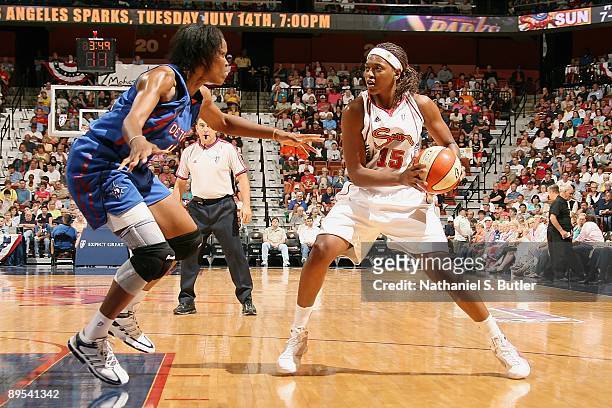 Asjha Jones of the Connecticut Sun drives the ball against Taj McWilliams of the Detroit Shock during the WNBA game on July 11, 2009 at Mohegan Sun...