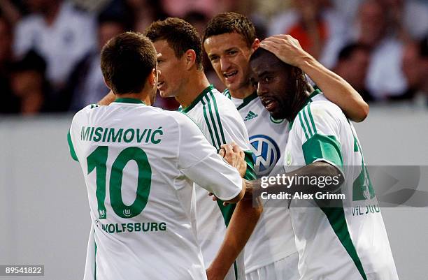 Grafite of Wolfsburg celebrates his team's first goal with team mates Christian Gentner, Edin Dzeko and Zvjezdan Misimovic during the DFB Cup first...