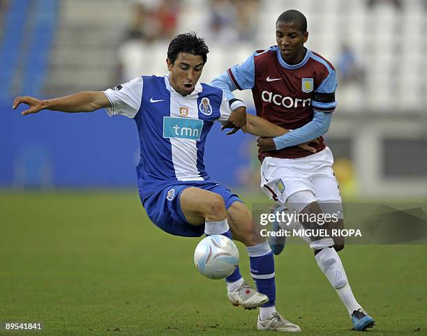 Aston Villa's player Ashley Young vies with FC Porto´s Jorge Fucile during their Peace Cup tournament semifinal football match on July 31, 2009 at...