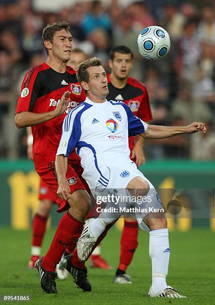 Anton Mueller of Potsdam battles for the ball with Stefan Reinartz of Leverkusen during the DFB Cup first round match between SV Babelsberg 03 and...