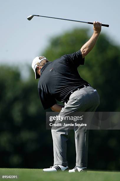 Fred Funk of the USA practices his swing while waiting to hit his second shot on the 18th hole during the second round of the 2009 U.S. Senior Open...