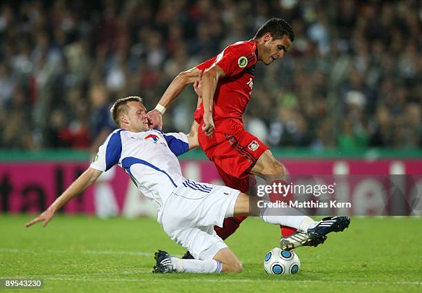 Augusto Renato of Leverkusen battles for the ball with Julian Prochnow of Potsdam during the DFB Cup first round match between SV Babelsberg 03 and...