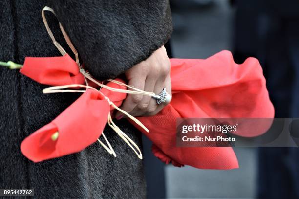 Woman holds a bouquet of flowers during a commemoration of Russian Envoy Andrei Karlov on the first anniversary of his death at the Russian Embassy...