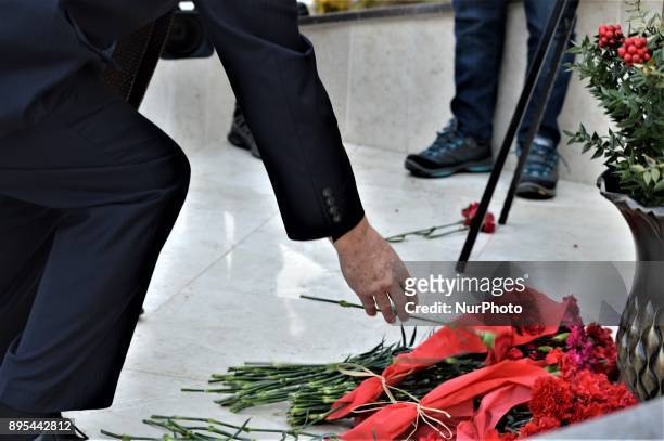 Man lays flowers in front of a statue of Russian Envoy Andrei Karlov during a commemoration on the first anniversary of his death at the Russian...