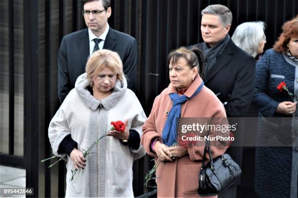 Russian women hold flowers during a commemoration of Russian Envoy Andrei Karlov on the first anniversary of his death at the Russian Embassy in...