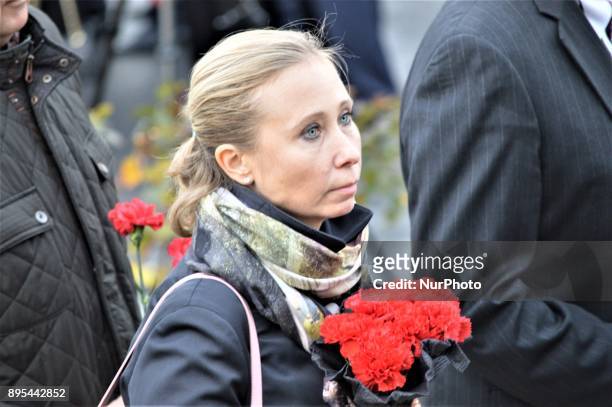 Russian woman holds flowers during a commemoration of Russian Envoy Andrei Karlov on the first anniversary of his death at the Russian Embassy in...