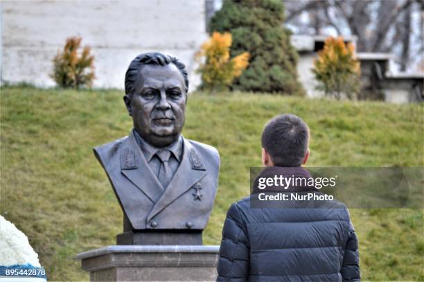 Man pays respect in front of a statue of Russian Envoy Andrei Karlov during a commemoration on the first anniversary of his death at the Russian...