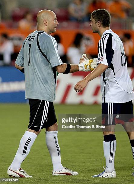 Goalie Matt Reis of the New England Revolution is congratulated by teammate Chris Tierney after the Houston Dynamo defeated the new England...