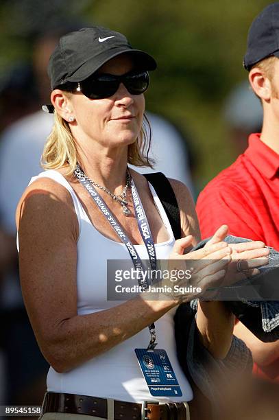Chris Evert applaudes as she watches husband Greg Norman putt on the 7th hole during the second round of the 2009 U.S. Senior Open on July 31, 2009...