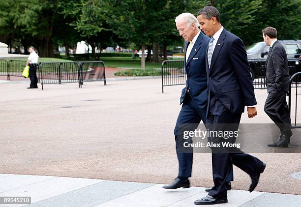 Vice President Joseph Biden and U.S. President Barack Obama walk to the Blair House from the White House prior to a meeting with cabinet members July...