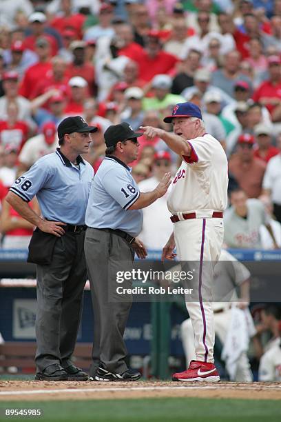 Manager Charlie Manuel of the Philadelphia Phillies and umpires Dan Iassogna and Charlie Relaford argue during the game against the Chicago Cubs at...