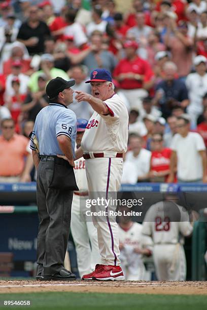 Manager Charlie Manuel of the Philadelphia Phillies and umpire Dan Iassogna argue during the game against the Chicago Cubs at Citizens Bank Park on...