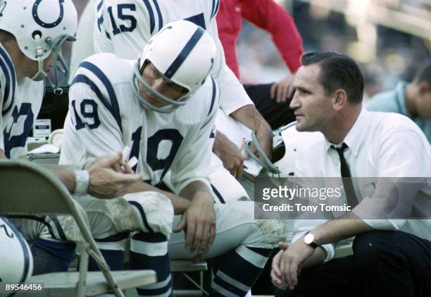Quarterback Johnny Unitas of the Baltimore Colts talks with coach Don Shula and wide receiver Raymond Berry on the sidelines during a game on October...