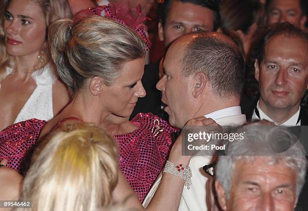 Charlene Wittstock and Prince Albert II of Monaco talk on the dancefloor as they attend the 61st Monaco Red Cross Ball at the Monte Carlo Sporting...