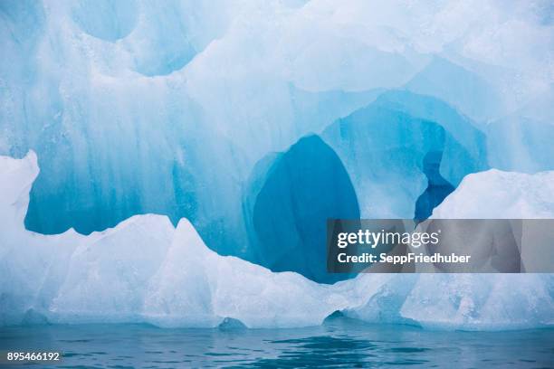 blue iceberg floating in the hornsund spitzbergen - arktis stock pictures, royalty-free photos & images