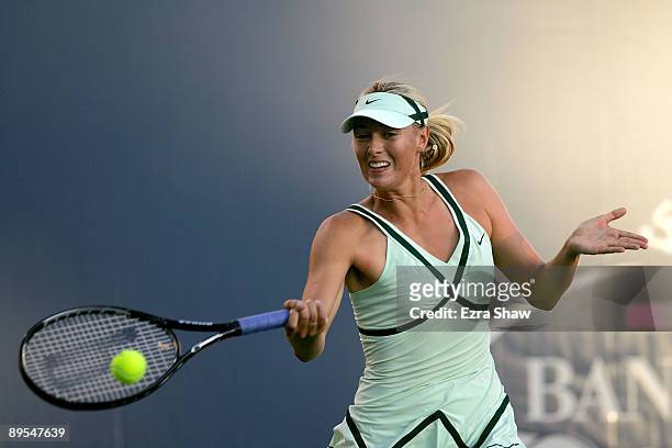 Maria Sharapova of the USA returns a shot to Venus Williams of the USA in their quarterfinal match on Day 5 of the Bank of the West Classic July 31,...