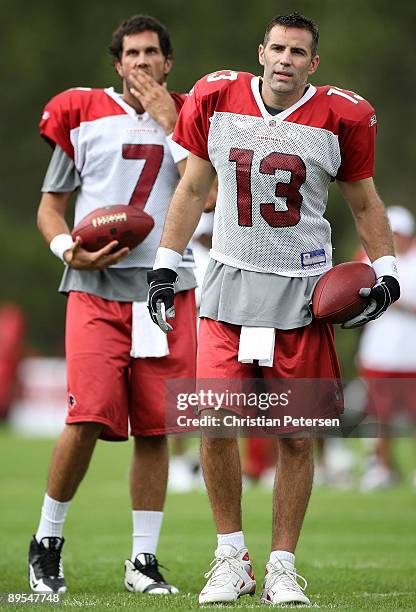 Quaterbacks Kurt Warner and Matt Leinart of the Arizona Cardinals stand on the field during the team training camp at Northern Arizona University on...