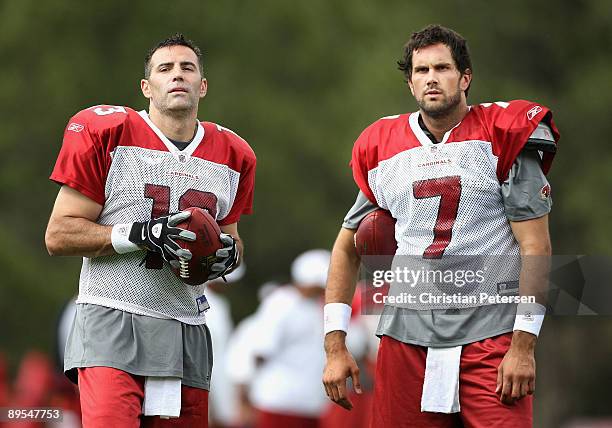 Quaterbacks Kurt Warner and Matt Leinart of the Arizona Cardinals stand on the field during the team training camp at Northern Arizona University on...