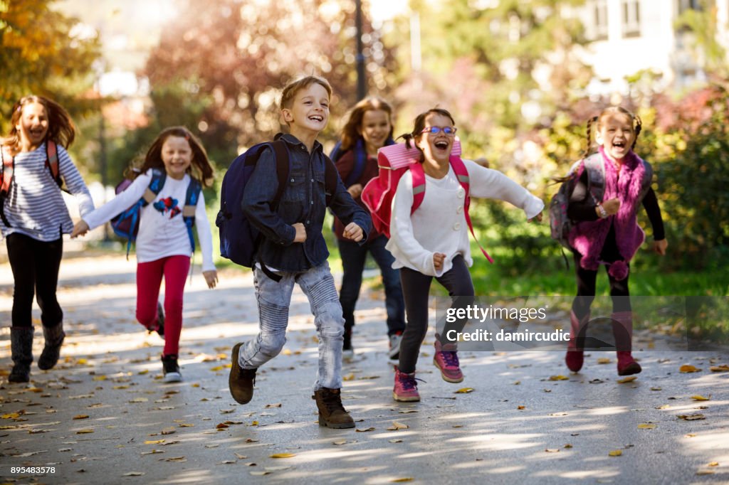 School kids running in schoolyard