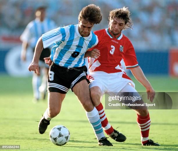 Gabriel Batistuta of Argentina and Trifon Ivanov of Bulgaria in action during a 1994 FIFA World Cup group game at the Cotton Bowl on June 30, 1994 in...