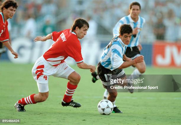 Ariel Ortega of Argentina and Tsanko Tsvetanov of Bulgaria in action during a 1994 FIFA World Cup group game at the Cotton Bowl on June 30, 1994 in...