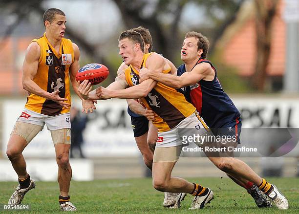 Travis Tuck of the Hawks handballs during the round 16 VFL match between the Coburg Tigers and the Box Hill Hawks at ABD Group Stadium on August 1,...