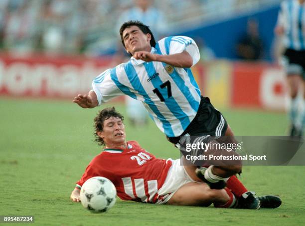 Krasimir Balakov of Bulgaria brings down Ariel Ortega of Argentina during a 1994 FIFA World Cup group game at the Cotton Bowl on June 30, 1994 in...