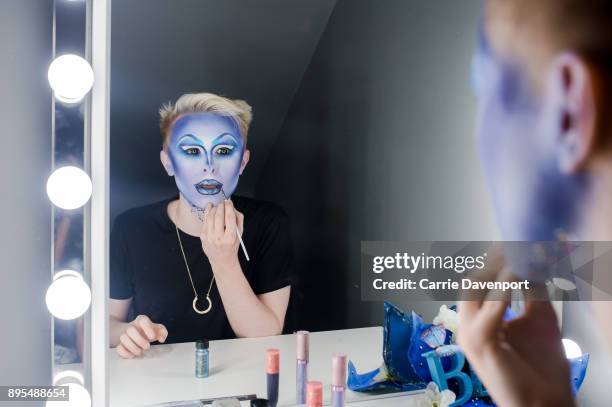 Joshua Cargill aka Blu Hydrangea is photographed getting into drag backstage as part 'Visage' a collaborative exhibition with designer Aaron Eakin...