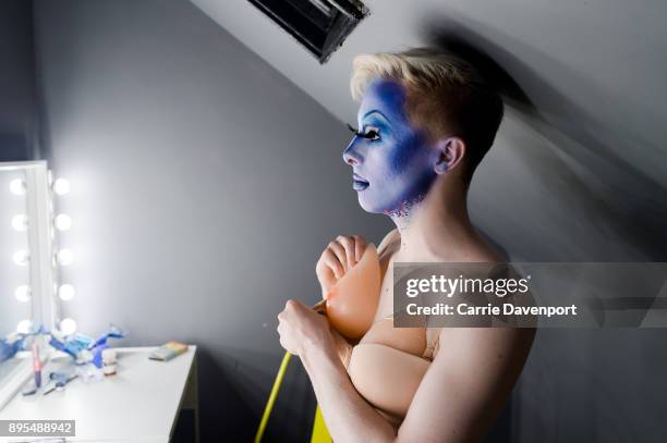 Joshua Cargill aka Blu Hydrangea is photographed getting into drag backstage as part 'Visage' a collaborative exhibition with designer Aaron Eakin...