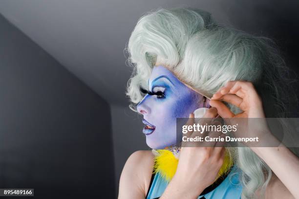 Joshua Cargill aka Blu Hydrangea is photographed getting into drag backstage as part 'Visage' a collaborative exhibition with designer Aaron Eakin...