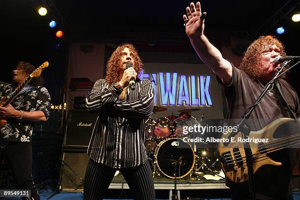 Guitarist Stuart Smith, singer Joe Retta and Bass player Steve Priest of the rock band "The Sweet" perform at Universal CityWalk's "Summer Block...