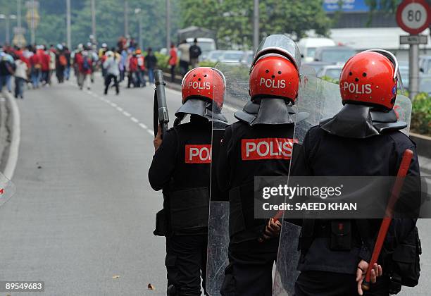 Malaysian anti-riot police prepare to fire tear gas shells to disperse demonstrators near Merdeka Square in Kuala Lumpur on August 1, 2009. Malaysian...