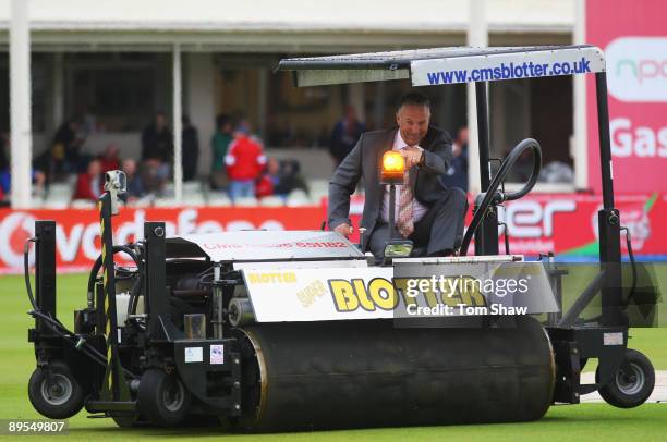 Sky commentator Ian Botham drives the Blotter to remove surface water after rain during day three of the npower 3rd Ashes Test Match between England...
