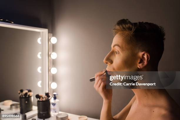 Matthew Cavan aka Cherrie Ontop is photographed getting into drag backstage as part 'Visage' a collaborative exhibition with designer Aaron Eakin and...