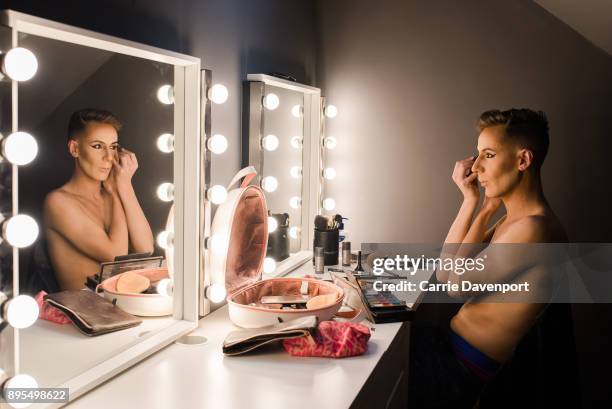 Matthew Cavan aka Cherrie Ontop is photographed getting into drag backstage as part 'Visage' a collaborative exhibition with designer Aaron Eakin and...