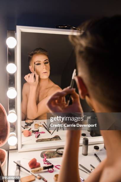 Matthew Cavan aka Cherrie Ontop is photographed getting into drag backstage as part 'Visage' a collaborative exhibition with designer Aaron Eakin and...
