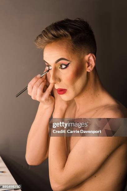 Matthew Cavan aka Cherrie Ontop is photographed getting into drag backstage as part 'Visage' a collaborative exhibition with designer Aaron Eakin and...