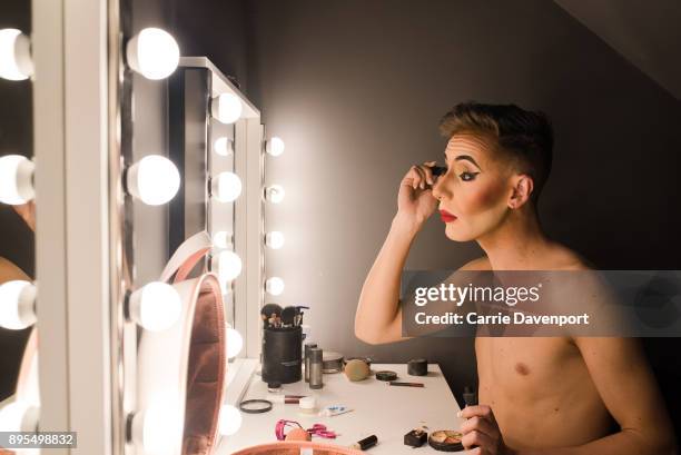 Matthew Cavan aka Cherrie Ontop is photographed getting into drag backstage as part 'Visage' a collaborative exhibition with designer Aaron Eakin and...