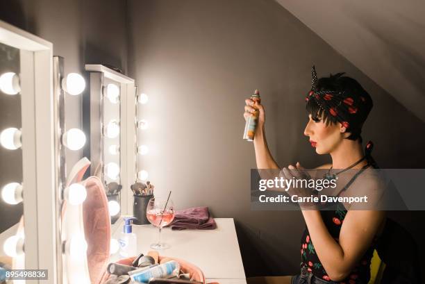 Matthew Cavan aka Cherrie Ontop is photographed getting into drag backstage as part 'Visage' a collaborative exhibition with designer Aaron Eakin and...