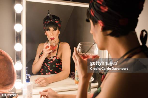 Matthew Cavan aka Cherrie Ontop is photographed getting into drag backstage as part 'Visage' a collaborative exhibition with designer Aaron Eakin and...