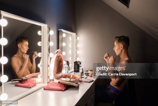 Matthew Cavan aka Cherrie Ontop is photographed getting into drag backstage as part 'Visage' a collaborative exhibition with designer Aaron Eakin and...