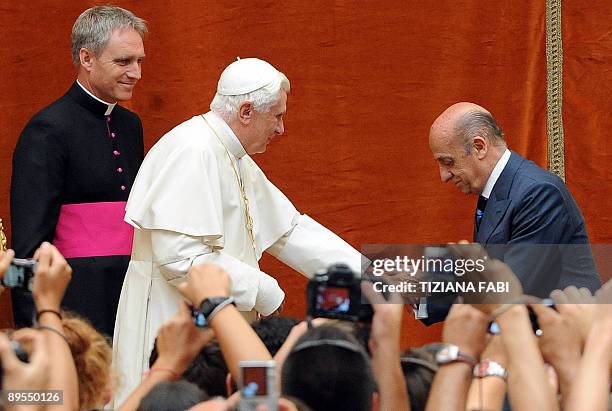 Pope Benedict XVI shakes hands with President of the International Swimming Federation Julio Maglione of Uruguay during the audience for competitors...