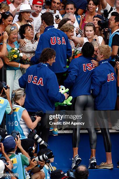 Michael Phelps of United States and the USA Team celebrate the gold medal with their families after winning the Men's 4x200m Freestyle Final, during...