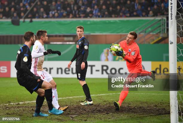 Michael Ratajczak of Paderborn makes a save from Stefan Lex of Ingolstadt during the DFB Cup match between SC Paderborn and FC Ingolstadt at Benteler...