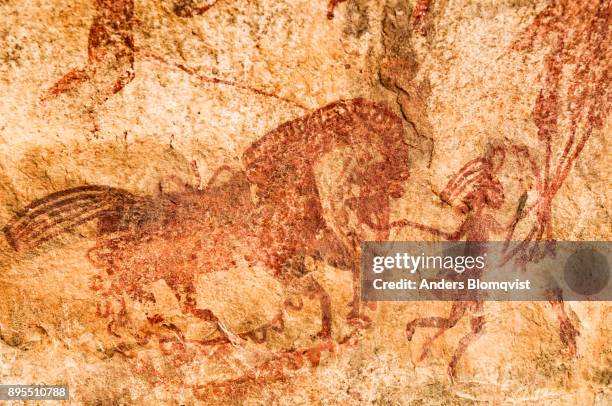 cave painting  from the upper paleolithic age of a man leading a horse at the world heritage bhimbetka rock shelters in madhya pradesh, india - cave drawings stock pictures, royalty-free photos & images