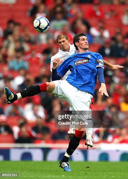 Kyle Lafferty of Rangers and Christophe Jallet of PSG compete for a header during the Emirates Cup match between Glasgow Rangers and Paris...