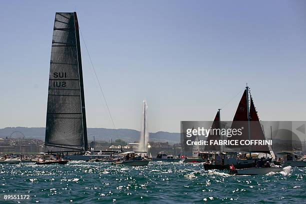 America's Cup defender Alinghi's new giant high tech catamaran "Alinghi 5" arrives in Geneva during its parade at Lake Geneva on the Swiss national...