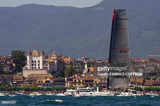 America's Cup defender Alinghi's new giant high tech catamaran "Alinghi 5" sails with the castel of Nyon as background during its parade at Lake...