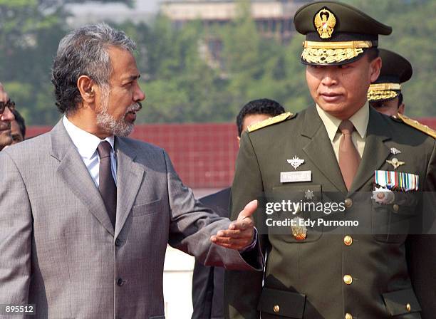 East Timorese President Xanana Gusmao talks with an Indonesian Army officer Major General TB. Hasanudin after attending flower wreath ceremony during...