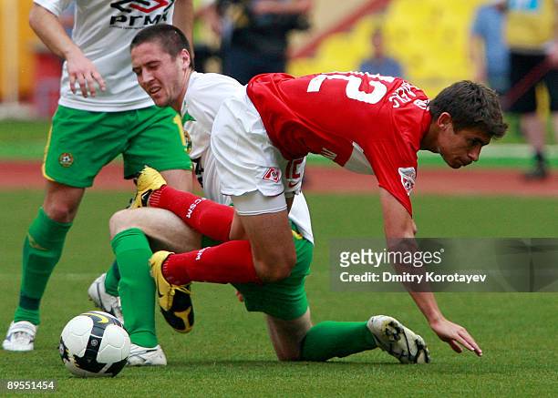 Alex of FC Spartak Moscow battles for the ball with Artur Tlisov of FC Kuban Krasnodar during the Russian Football League Championship match between...